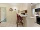 Eat-in kitchen featuring a breakfast bar with seating, and tile flooring at 7470 Princeton Trce, Sandy Springs, GA 30328
