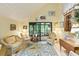 Bright sunroom with a vaulted ceiling, comfortable seating, and a view of the lush backyard; creating a peaceful and airy space at 7470 Princeton Trce, Sandy Springs, GA 30328