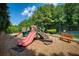 Community playground featuring slides, climbing structures, and a nearby bench for relaxation at 7470 Princeton Trce, Sandy Springs, GA 30328