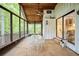 Relaxing screened porch with a wooden ceiling, tile floors, and an outdoor dining set, perfect for enjoying nature views at 7470 Princeton Trce, Sandy Springs, GA 30328