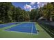Beautiful tennis courts with trees around in a park-like setting with lighting at 7470 Princeton Trce, Sandy Springs, GA 30328