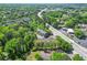 Aerial view of neighborhood with mature trees, shopping areas, and roadways at 1561 Mosaic Way, Smyrna, GA 30080