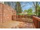 Outdoor wooden deck showcasing the brick home and landscaped backyard at 1561 Mosaic Way, Smyrna, GA 30080