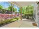 Covered back patio with concrete slab overlooking landscaped yard and privacy fence at 1561 Mosaic Way, Smyrna, GA 30080
