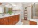 Bathroom featuring double sinks, wood cabinets, tiled floor, and a glass shower at 1561 Mosaic Way, Smyrna, GA 30080
