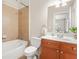 Bathroom featuring tub-shower combination, wood vanity, and updated fixtures at 1561 Mosaic Way, Smyrna, GA 30080