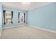 Bright bedroom with two windows, neutral carpet, and light blue walls at 1561 Mosaic Way, Smyrna, GA 30080