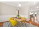 Well-lit dining area with modern chairs, hardwood floors, and open access to other rooms at 1561 Mosaic Way, Smyrna, GA 30080
