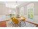 Bright dining room featuring contemporary yellow chairs, hardwood floors, and natural light at 1561 Mosaic Way, Smyrna, GA 30080