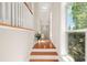 Bright hallway with hardwood floors, large windows, and white trim leading to the main living areas and the upper floor at 1561 Mosaic Way, Smyrna, GA 30080