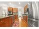 Open kitchen with granite countertops, stainless steel appliances, hardwood floors, and center island with bar stool seating at 1561 Mosaic Way, Smyrna, GA 30080