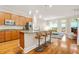 Open kitchen with granite countertops, stainless steel appliances, hardwood floors, and center island with bar stool seating at 1561 Mosaic Way, Smyrna, GA 30080