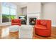 Cozy living room featuring hardwood floors, a modern fireplace, and lots of natural light streaming in from the surrounding windows at 1561 Mosaic Way, Smyrna, GA 30080