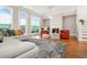 Cozy living room featuring hardwood floors, a modern fireplace, and lots of natural light streaming in from the surrounding windows at 1561 Mosaic Way, Smyrna, GA 30080