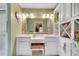 Bright bathroom with double sink vanity, decorative mirror, and ample storage space at 1826 Bedfordshire Ct, Decatur, GA 30033