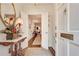 Inviting entryway with hardwood floors, a stylish table with fresh flowers, and a glimpse into the living spaces at 1826 Bedfordshire Ct, Decatur, GA 30033