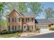 Beautiful brick home featuring a two-car garage, front garden and manicured lawn, situated among mature trees at 1826 Bedfordshire Ct, Decatur, GA 30033