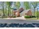 Side and front exterior view of a brick home featuring an attached two-car garage at 1826 Bedfordshire Ct, Decatur, GA 30033