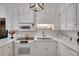 Bright kitchen with white cabinetry, sleek countertops, and modern stainless steel appliances at 1826 Bedfordshire Ct, Decatur, GA 30033
