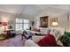 Well-lit living room with neutral sectional, wood floors, area rug, and vaulted ceilings at 1826 Bedfordshire Ct, Decatur, GA 30033