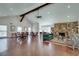 Open-concept living room with hardwood floors, stone fireplace, and large windows offering plenty of light at 1826 Bedfordshire Ct, Decatur, GA 30033