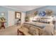 Comfortable main bedroom with blue walls, plush bedding, and natural light at 1826 Bedfordshire Ct, Decatur, GA 30033