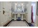 Elegant bathroom with dual sinks, decorative tile flooring, and soft lighting at 3593 Hemphill St, Atlanta, GA 30337