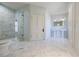 Bathroom with marble tile, glass shower, and separate pedestal sinks at 3593 Hemphill St, Atlanta, GA 30337