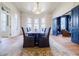 Formal dining room boasting a large table, chandelier, and expansive windows with colorful panes at 3593 Hemphill St, Atlanta, GA 30337