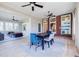 Dining room with brick accent wall, built-in shelves, large windows, and ceiling fan at 3593 Hemphill St, Atlanta, GA 30337