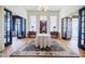 Elegant foyer with hardwood floors, grand doorways, decorative rug, and a table with floral arrangement at 3593 Hemphill St, Atlanta, GA 30337