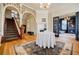 Grand foyer showcasing a staircase, hardwood floors, decorative rug, and elaborate trim and millwork at 3593 Hemphill St, Atlanta, GA 30337