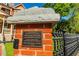 Historical brick pillar with cast iron fencing showing a plaque designating The Palmour House to the historic registry at 3593 Hemphill St, Atlanta, GA 30337