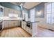Bright kitchen with modern stainless steel appliances, white cabinets, and large windows with decorative glass at 3593 Hemphill St, Atlanta, GA 30337