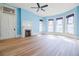 Spacious room featuring fireplace, hardwood floor, and stained glass windows at 3593 Hemphill St, Atlanta, GA 30337