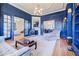 Cozy living room with fireplace, built-in bookshelves, large windows and open access to other rooms at 3593 Hemphill St, Atlanta, GA 30337