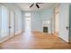 Bright living room with wood floors, decorative fireplace, and open doorway showcasing the home's architectural details at 3593 Hemphill St, Atlanta, GA 30337