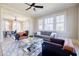 Bright living room featuring large windows, a ceiling fan, hardwood floors, and modern furniture at 3593 Hemphill St, Atlanta, GA 30337
