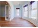 Cozy sitting area with three stained glass windows, hardwood floors, and adjacent room entry at 3593 Hemphill St, Atlanta, GA 30337