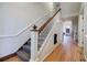 Traditional staircase featuring detailed wood trim and neutral carpeting leading to the upper level of the home at 3593 Hemphill St, Atlanta, GA 30337