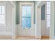 Hallway with custom windows with decorative glass, custom trim, and white wainscoting at 3593 Hemphill St, Atlanta, GA 30337