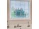 Close-up of a bathtub with tiled surround and window view, featuring a modern design at 2121 Silva Ct, Conley, GA 30288