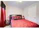 Bedroom with red silk bedding, black accents, two windows and a white door at 2121 Silva Ct, Conley, GA 30288