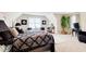 Spacious bedroom with a large bed, artwork, and a view of the neighborhood at 2121 Silva Ct, Conley, GA 30288