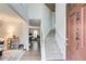 Bright foyer with staircase, hardwood floors, and view into living areas at 2121 Silva Ct, Conley, GA 30288