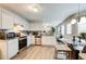 Eat-in kitchen with white cabinets, stainless steel appliances, and ample counter space at 2121 Silva Ct, Conley, GA 30288
