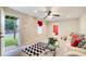 Bright living room with an outdoor view, ceiling fan, and access to the backyard at 2121 Silva Ct, Conley, GA 30288