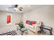 Comfortable living room with neutral carpet, ceiling fan, and a view to the bathroom at 2121 Silva Ct, Conley, GA 30288