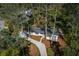 Aerial view of a home surrounded by mature trees and a driveway leading up to the house at 2590 Hawthorne Ne Pl, Atlanta, GA 30345