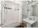 Bathroom featuring a tub with shower, black and white tiles and pedestal sink at 2590 Hawthorne Ne Pl, Atlanta, GA 30345